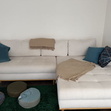 White sofa with cushions and blankets