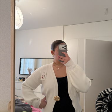 white vest with brooch