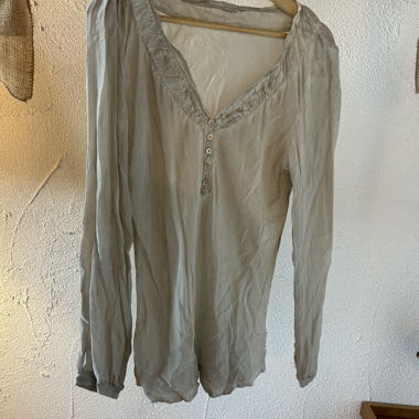 Beige long-sleeve blouse with button placket
