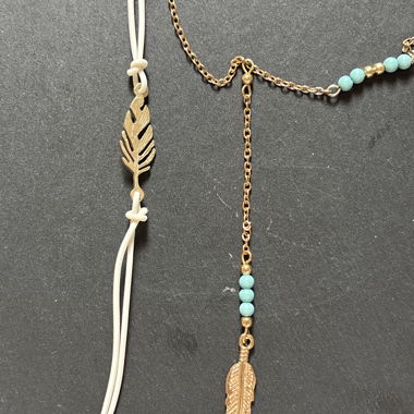 Necklace and bracelet set with feather