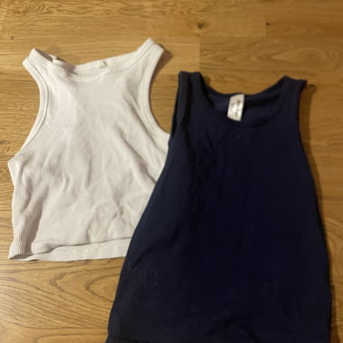2 sleeveless tops, white & dark blue