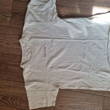 Beige t-shirt with purple lettering