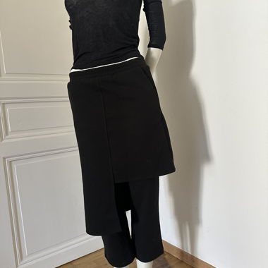 Black trousers with asymmetric skirt overlay