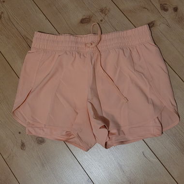 Peach-coloured sports shorts