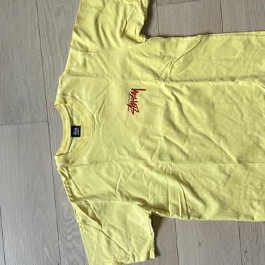 T-shirt gialla con grafica Stussy