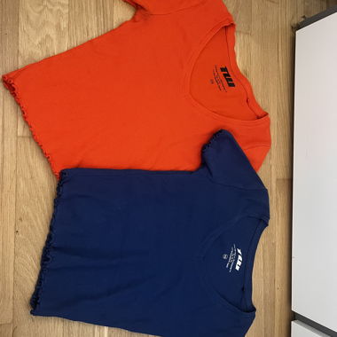 2 orange and blue tops