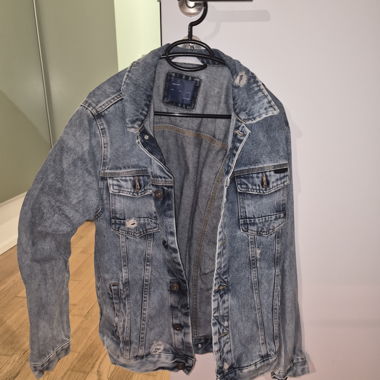 Giacca di jeans sbiadita con strappi