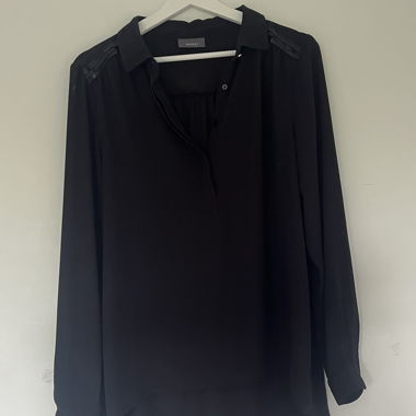 Schwarze Bluse mit Detail an Schulter