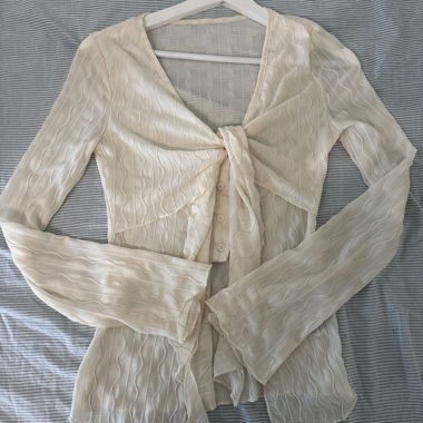 Cream-coloured sheer blouse