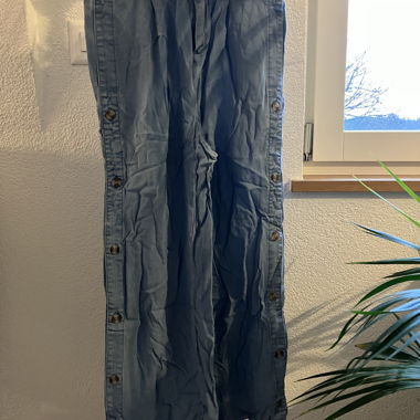 Light blue wide trousers with button placket