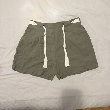 Green linen shorts with white drawstring