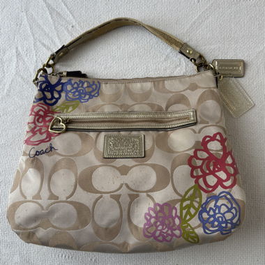 beige coach shoulder bag with flower print 