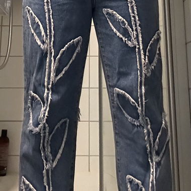Jeans with patched flower pattern