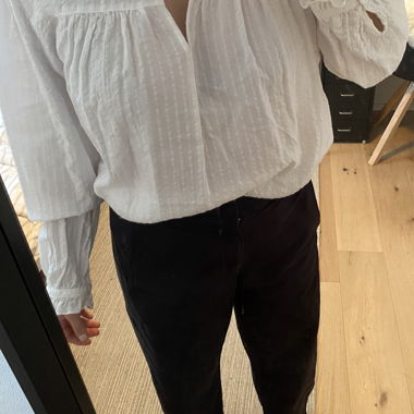 Blusa bianca con collo alto arricciato