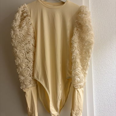 Off-white top with flowers on the sleeves