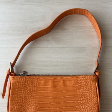 Orange crocodile patterned baguette bag