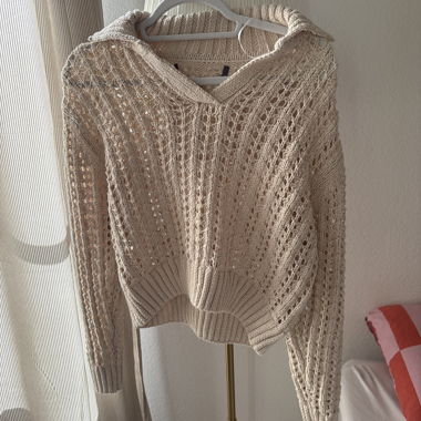 Beige knit sweater with openwork pattern