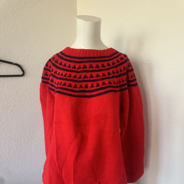 Red sweater in a beautiful neckline pattern 