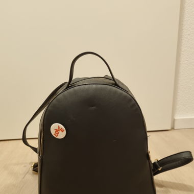 black faux leather bag with pin