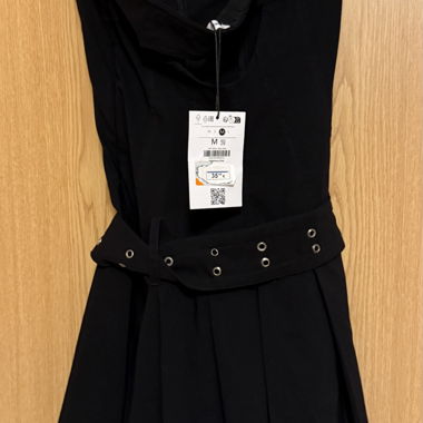 Black dress with black skirt with belts