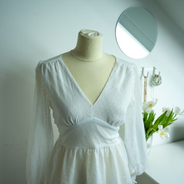 White wrap blouse with polka dot pattern