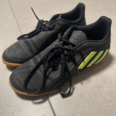 Black indoor sports shoes with neon stripes