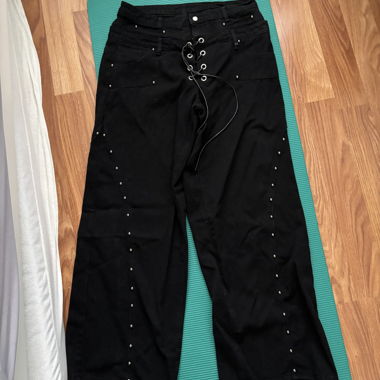 Wide black pants with lacing and studs