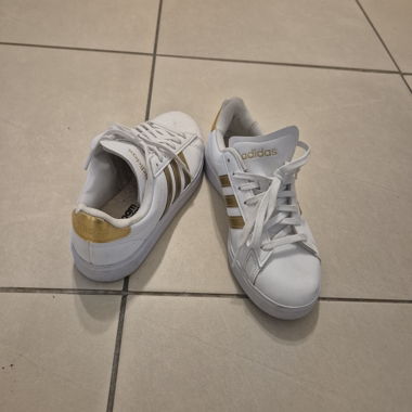 White and gold Adidas sneakers