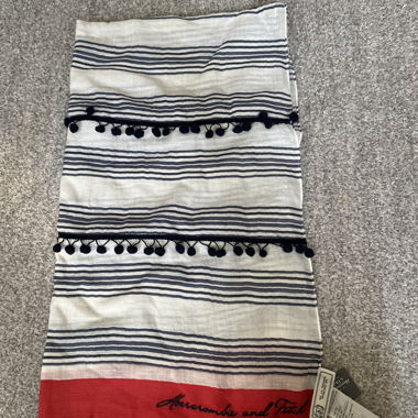 Striped scarf with pom-poms