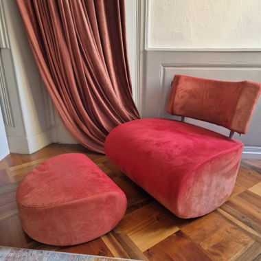 Red-orange designer armchair with footrest