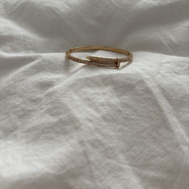 Gold-coloured bangle with rhinestones