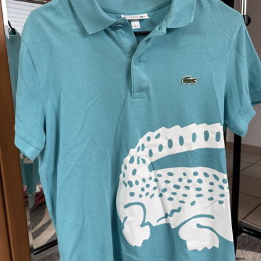 Polo Lacoste turchese con motivo coccodrillo