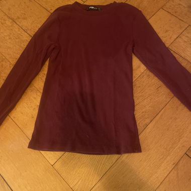 Burgundy-colored long sleeve.