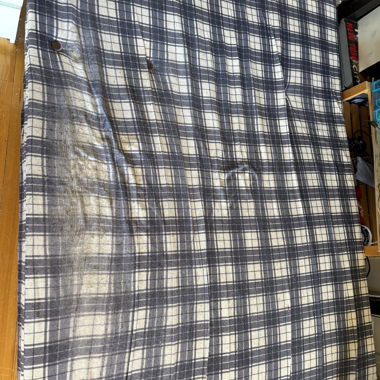 Fold-out sofa bed with check pattern