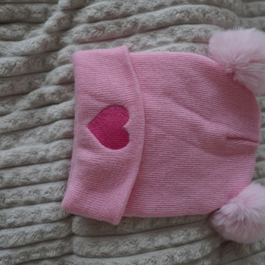 Pink beanie with pom-poms