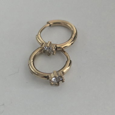 Gold-colored hoop earrings with stone