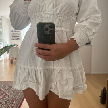White mini dress with ruffle detailing