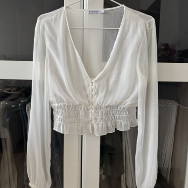 Blusa corta bianca a manica lunga