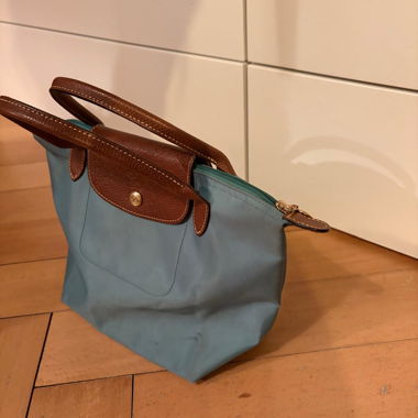 Small light blue handbag with leather handles
