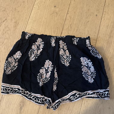 Kurze gemusterte schwarze Hose
