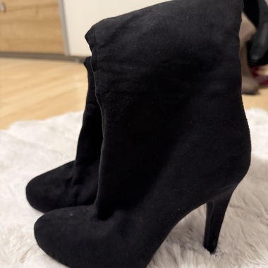 Black knee-high boots with high heel