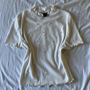 White top adorned with pearls