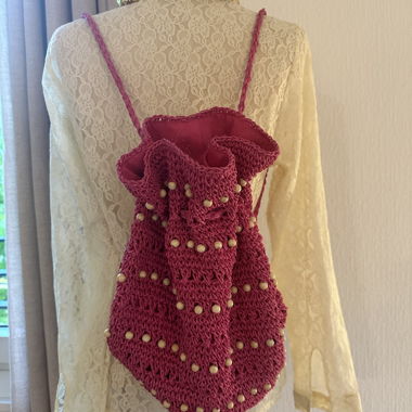 Fuchsia crochet backpack pouch with wooden beads