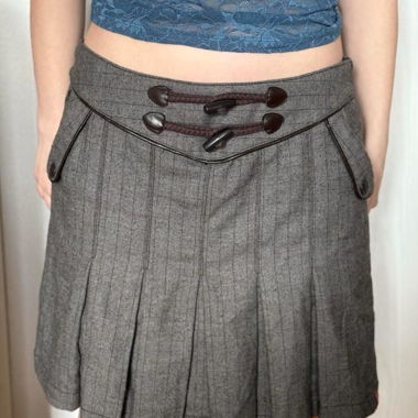 grey pleated skirt with brown leather detail
