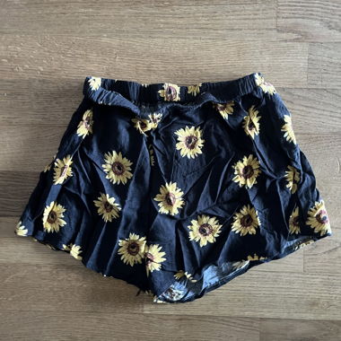 Black shorts with sunflower pattern