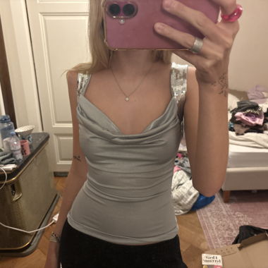 Silver satin sleeveless top with deep cutout