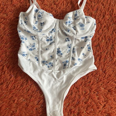 White bodysuit with blue flowers