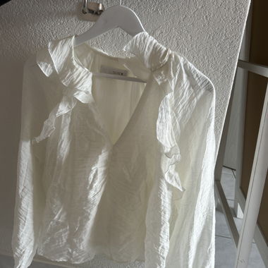 White ruffle blouse