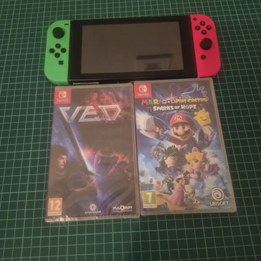 Nintendo Switch with neon Joy-Cons plus 2 games