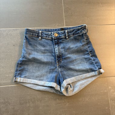 Mid-blue denim shorts, rolled up